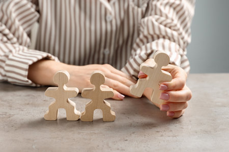 Woman with human figures at light table, closeupの写真素材