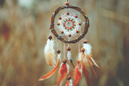 Shamanism. Beautiful dream catcher hanging outdoors, closeup