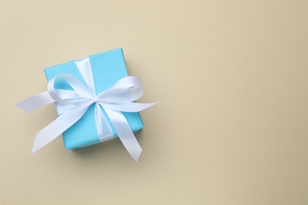Beautiful gift box on beige background, top view. Space for textの写真素材