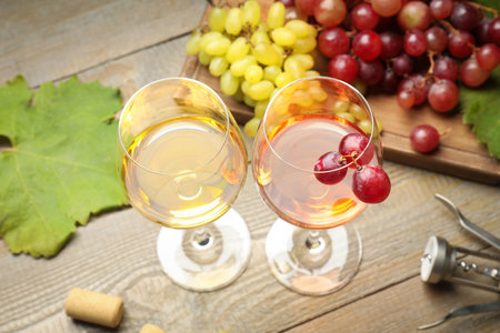Tasty rose and white wine, grapes, corkscrew on wooden table, closeupの写真素材