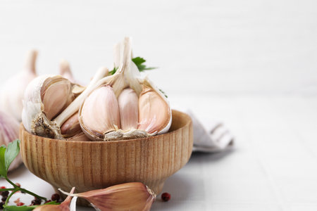 Garlic and parsley on white table, closeup. Space for textの写真素材