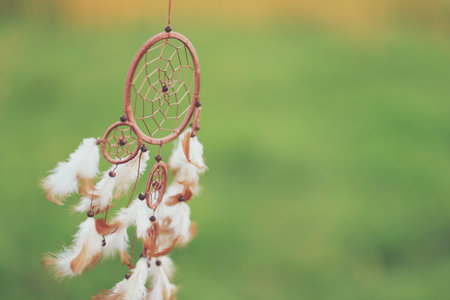 Shamanism. Beautiful dream catcher hanging outdoors, closeup. Space for textの写真素材