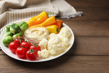Different fresh vegetables and sauce on wooden table, closeupの写真素材