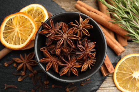 Different spices, dry orange slices and fresh rosemary for mulled wine on table, flat layの写真素材