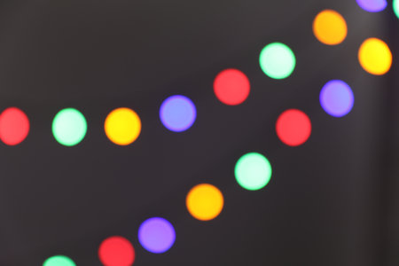 Bright Christmas lights on gray background, bokeh effectの写真素材