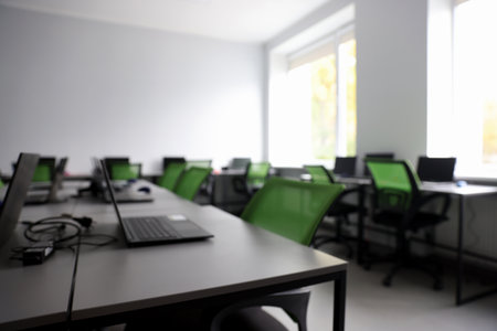 Blurred view of computer stylish class with laptops at schoolの写真素材