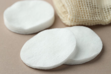 Clean cotton pads on beige background, closeupの写真素材