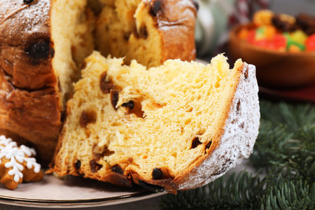 Tasty panettone cake, candied fruits and Christmas decor on table, closeupの写真素材