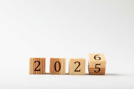 Flipping cube with number 5 and 6 to make 2026 on light background, closeupの写真素材