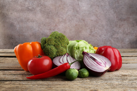 Different fresh raw vegetables on wooden table, closeupの写真素材