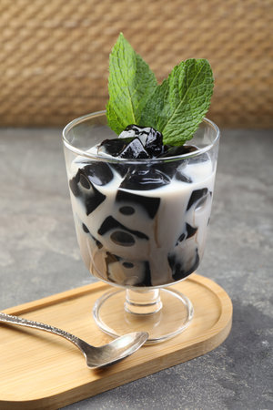 Tasty herbal jelly with milk and mint served on gray table, closeupの写真素材