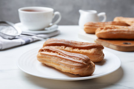 Delicious eclairs served on white table, closeupの写真素材