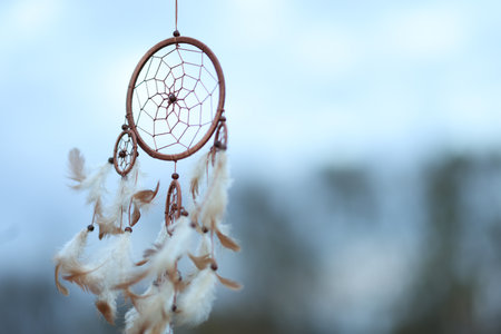 Shamanism. Beautiful dream catcher hanging outdoors, closeup. Space for textの写真素材