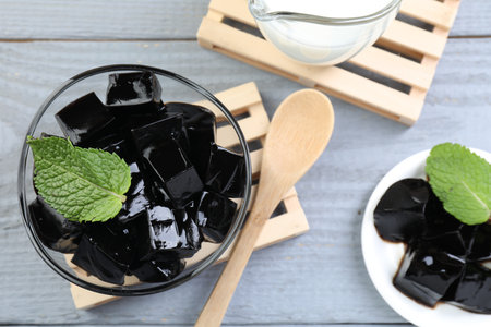 Tasty herbal jelly, mint and milk on gray wooden table, flat layの写真素材