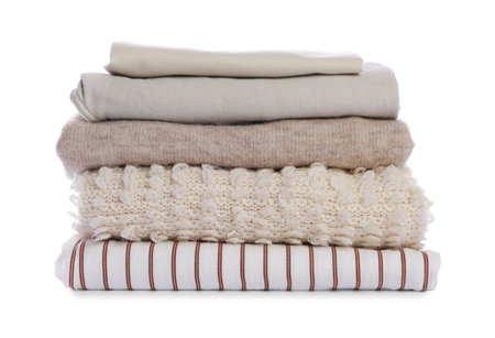 Stack of folded clothes isolated on whiteの写真素材