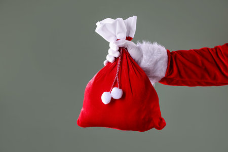 Santa Claus holding sack on gray background, closeup with space for text. Merry Christmas and Happy New Yearの写真素材