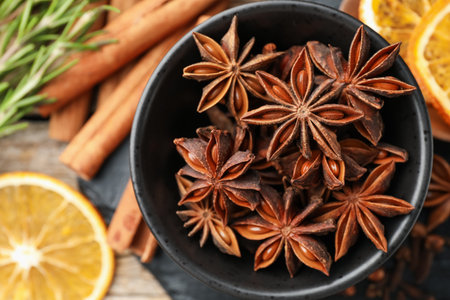 Different spices, dry orange slices and fresh rosemary for mulled wine on table, flat layの写真素材