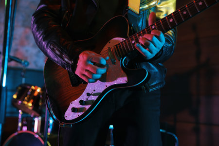 Man playing electric guitar on stage, closeupの写真素材