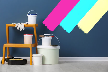 Decorator's stuff in room near wall partly painted in different shades. Choosing color for interiorの写真素材