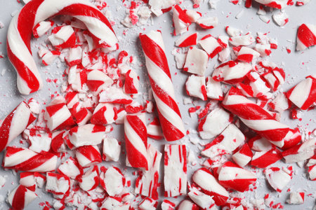 Crushed candy canes on gray background, flat lay. Christmas treatの写真素材