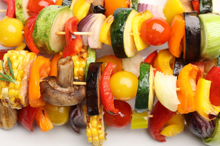 Skewers with tasty grilled vegetables on white table, closeupの写真素材