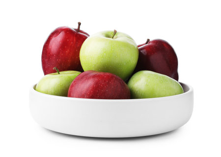 Red and green ripe apples in bowl isolated on whiteの写真素材