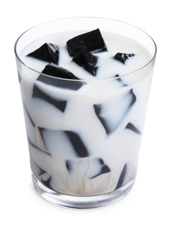 Glass of milk with tasty herbal jelly isolated on whiteの写真素材