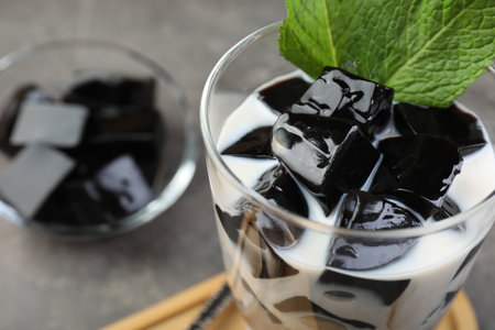 Tasty herbal jelly with milk and mint served on gray table, closeupの写真素材