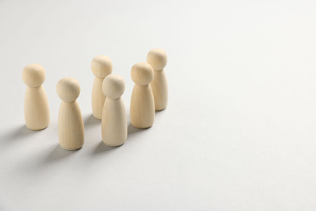 Many human figures on white table, closeup. Space for textの写真素材