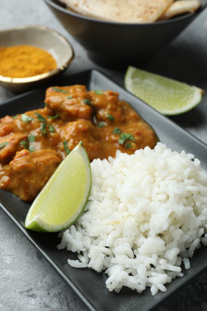 Chicken tikka masala with rice served on gray textured table, closeupの写真素材