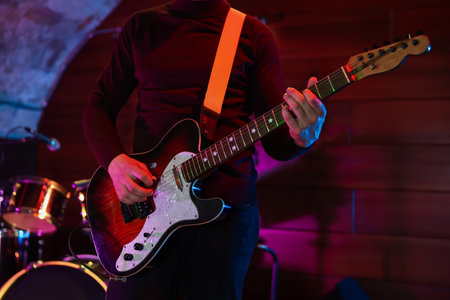 Man playing electric guitar on stage, closeupの写真素材