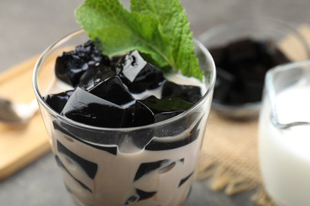 Tasty herbal jelly with milk and mint served on gray table, closeupの写真素材