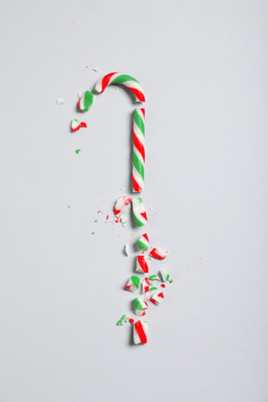 Crushed candy cane on gray background, flat lay. Christmas treatの写真素材
