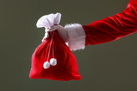 Santa Claus with sack on gray background, closeup. Merry Christmas and Happy New Yearの写真素材