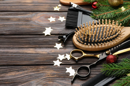 Different hairdresser's tools and Christmas decor on wooden table, closeup. Space for textの写真素材