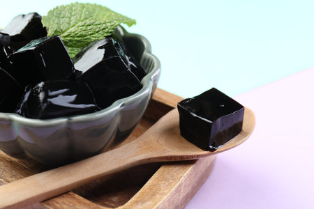 Tasty herbal jelly and mint leaf on color background, closeupの写真素材