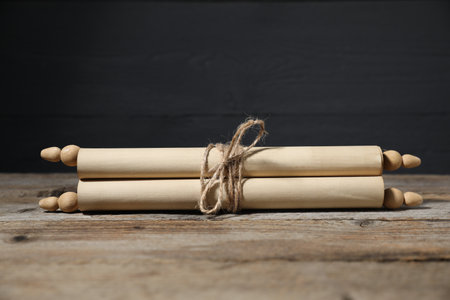 Old paper scroll on wooden table.の写真素材