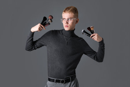 Makeup artist with set of brushes on gray backgroundの写真素材