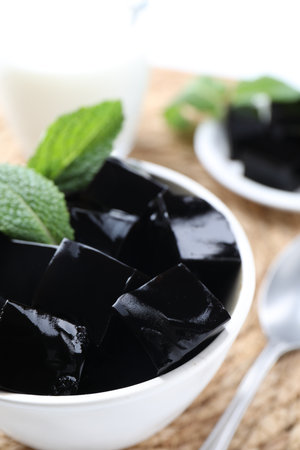 Tasty herbal jelly with mint leaves served on table, closeupの写真素材