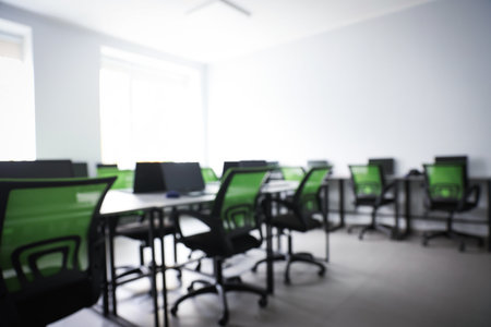 Blurred view of computer stylish class with laptops at school