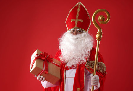 Saint Nicholas with gift and crozier on red backgroundの写真素材