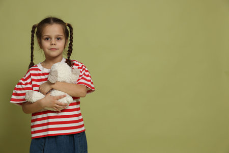 Cute little girl with toy sheep, space for textの写真素材