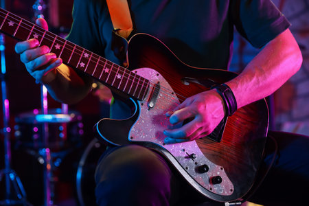Man playing electric guitar on stage, closeupの写真素材