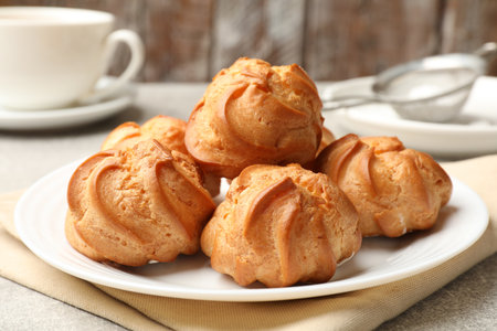 Delicious profiteroles on light gray table, closeupの写真素材