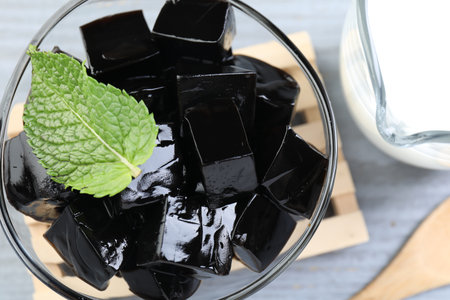 Tasty herbal jelly, mint and milk on table, flat layの写真素材