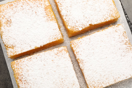 Tasty lemon bars with powdered sugar on table, top viewの写真素材