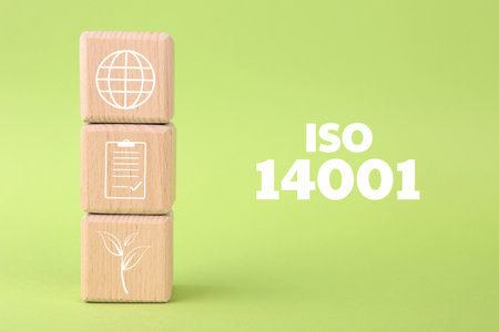 ISO 14001 Environmental management systems. Wooden cubes with different icons on light green backgroundの写真素材