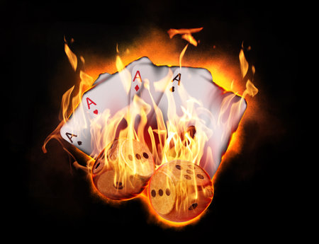 Dice and playing cards in flames on black background. Gambling gameの写真素材