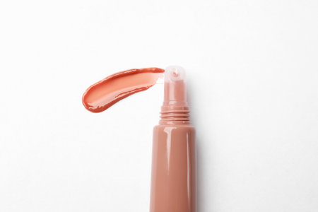 Beautiful nude lip gloss on white background, top viewの写真素材