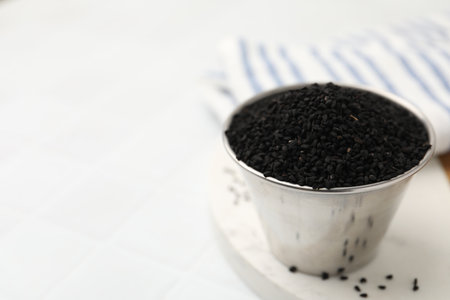 Aromatic black caraway in bowl on white table, closeup.の写真素材